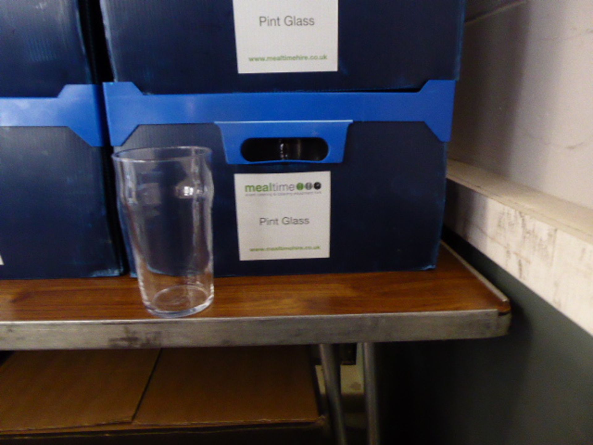 Stack of 6 plastic boxes containing approximately 90 pint glasses