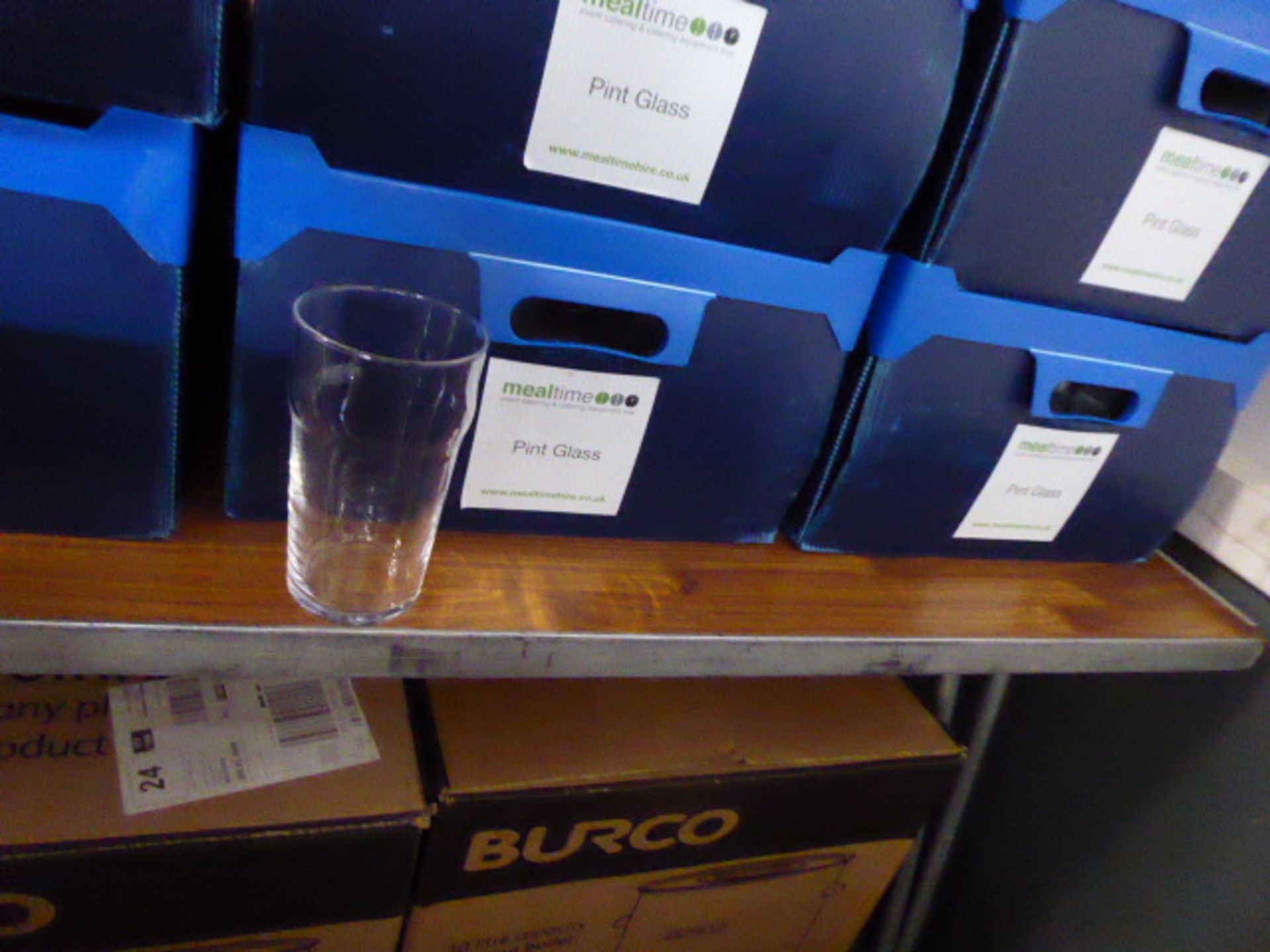 Stack of 6 plastic boxes containing approximately 90 pint glasses