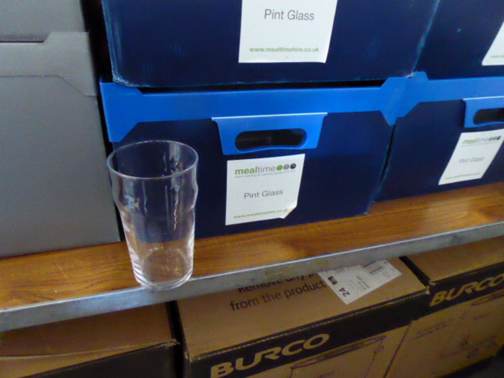 Stack of 4 plastic boxes containing approximately 60 pint glasses