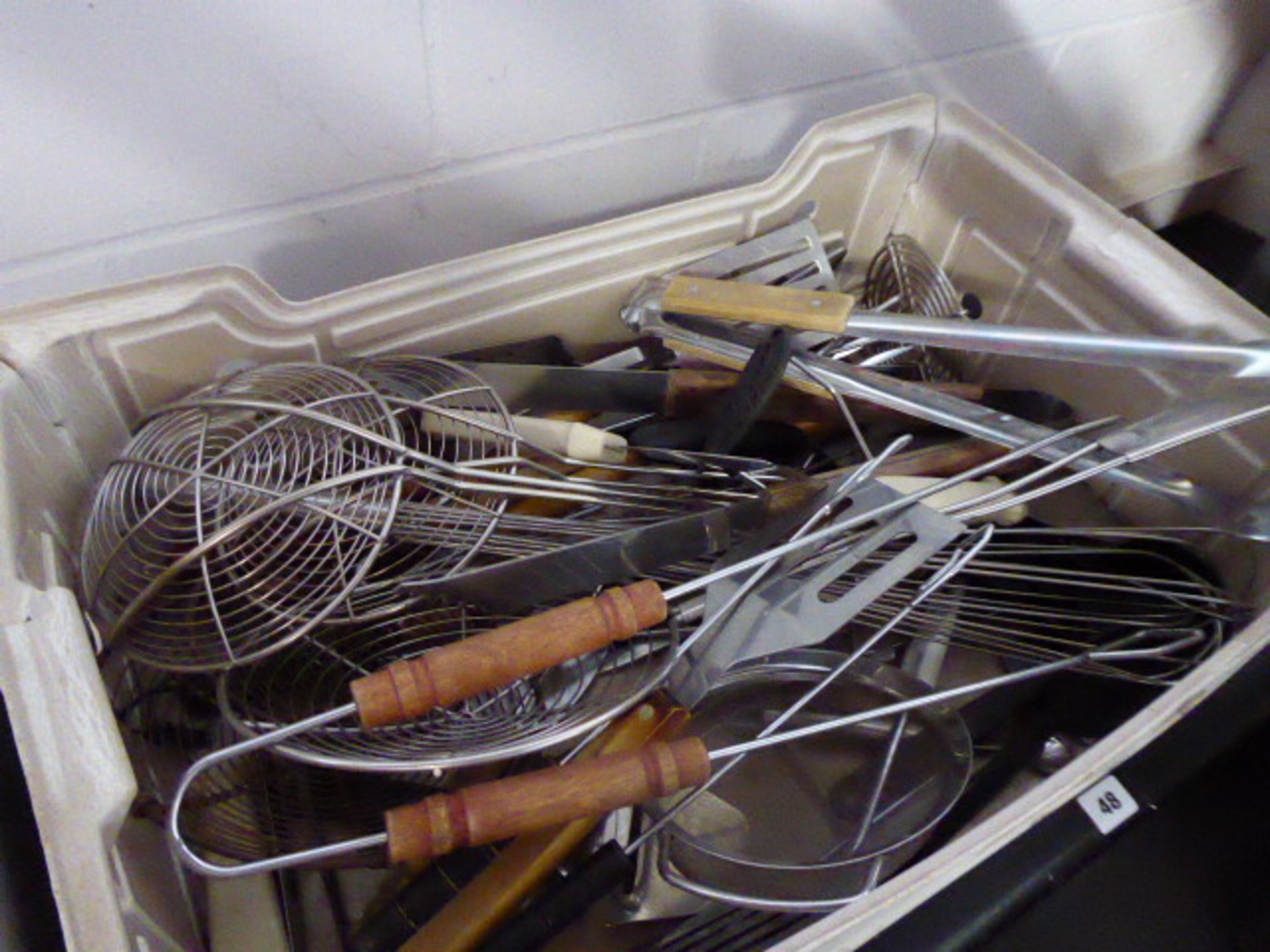 Large tray of utensils including skimmers, barbecue tools, etc