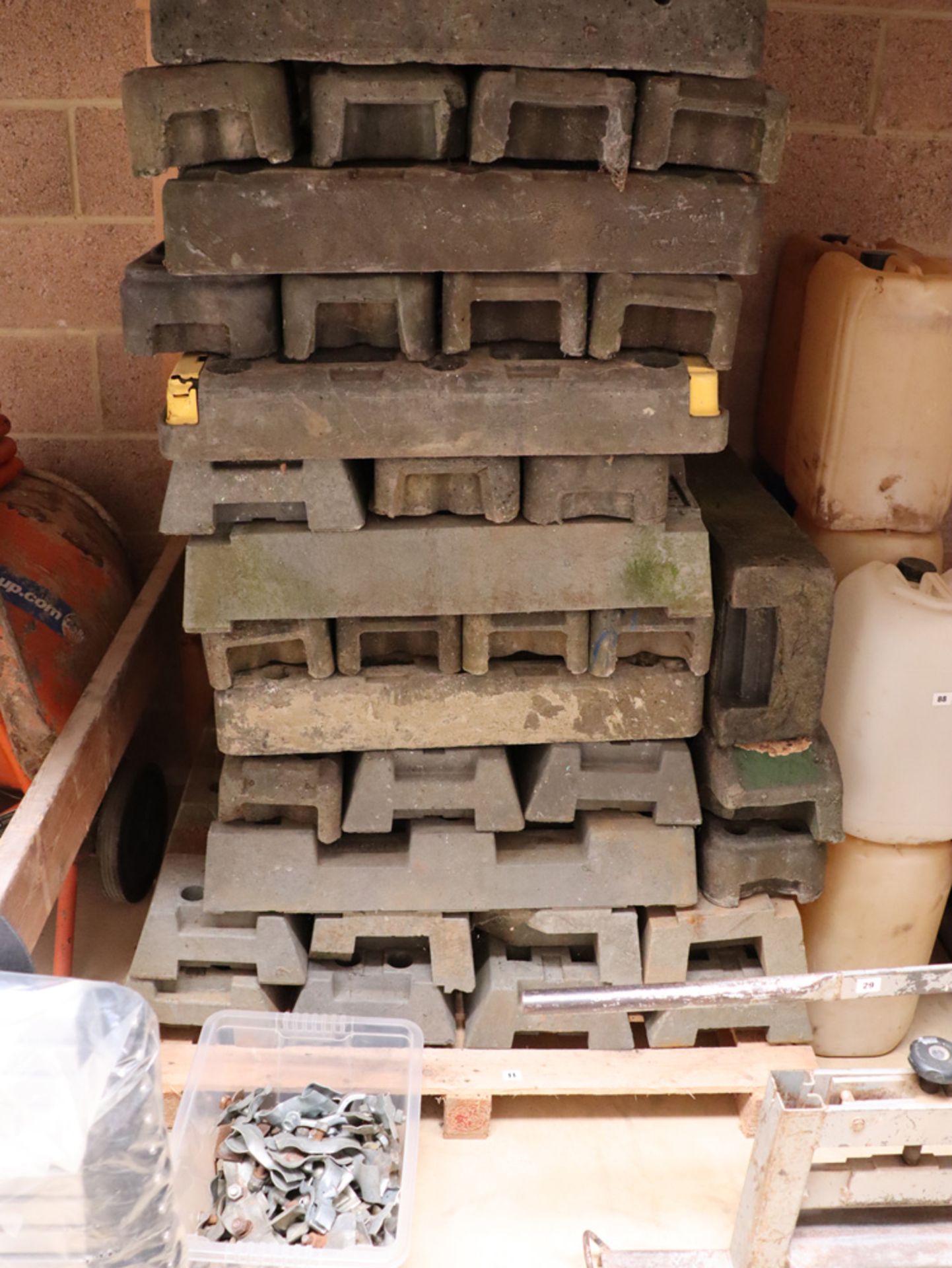 Approx. 50 Heras fencing feet with a box of Heras fencing clamps