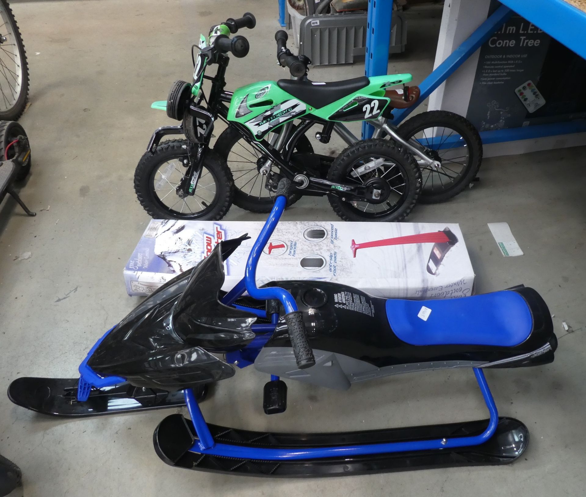 Boxed snow scooter, plastic snow buggy and two small children's bikes