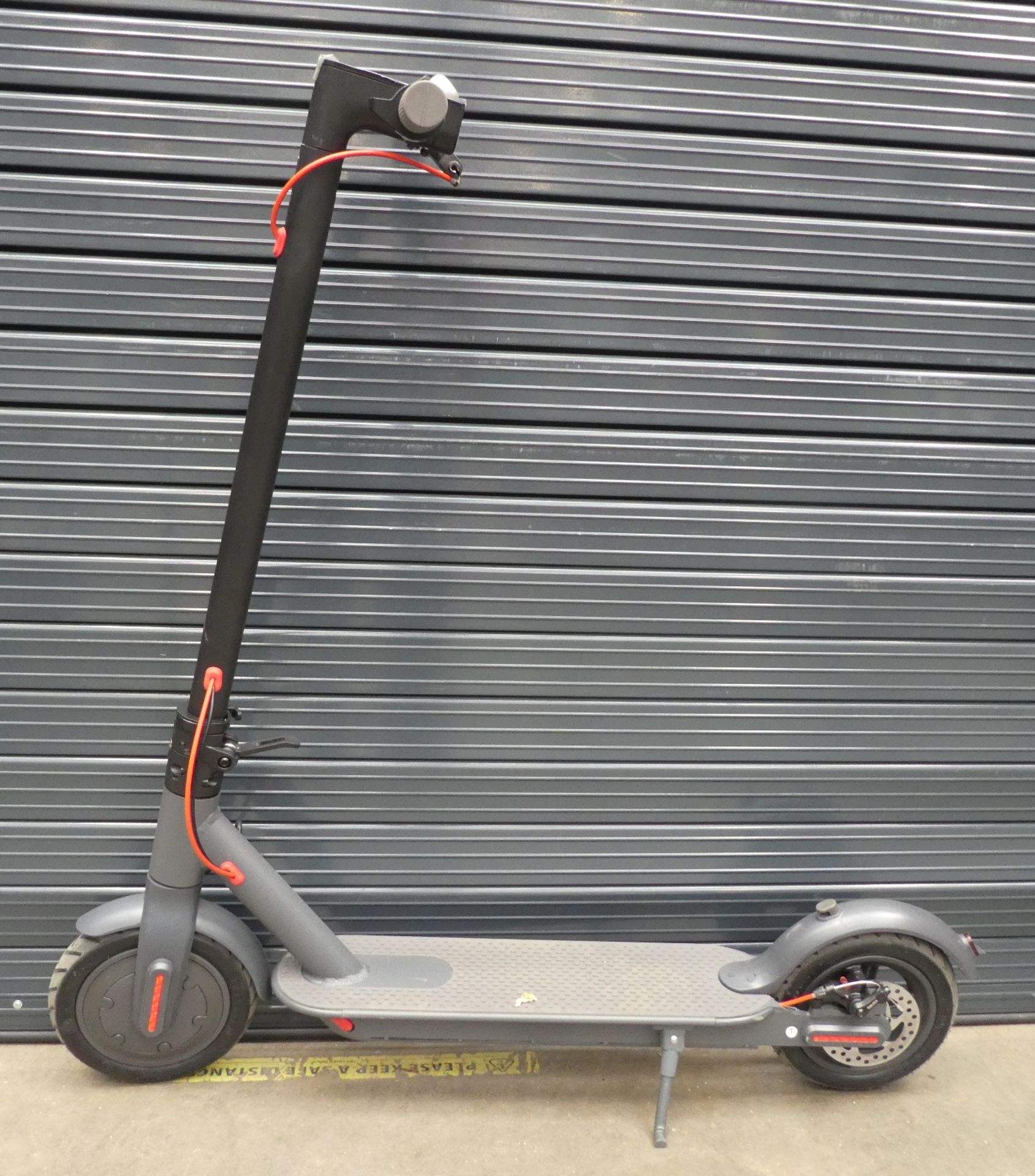 Grey electric scooter with charger