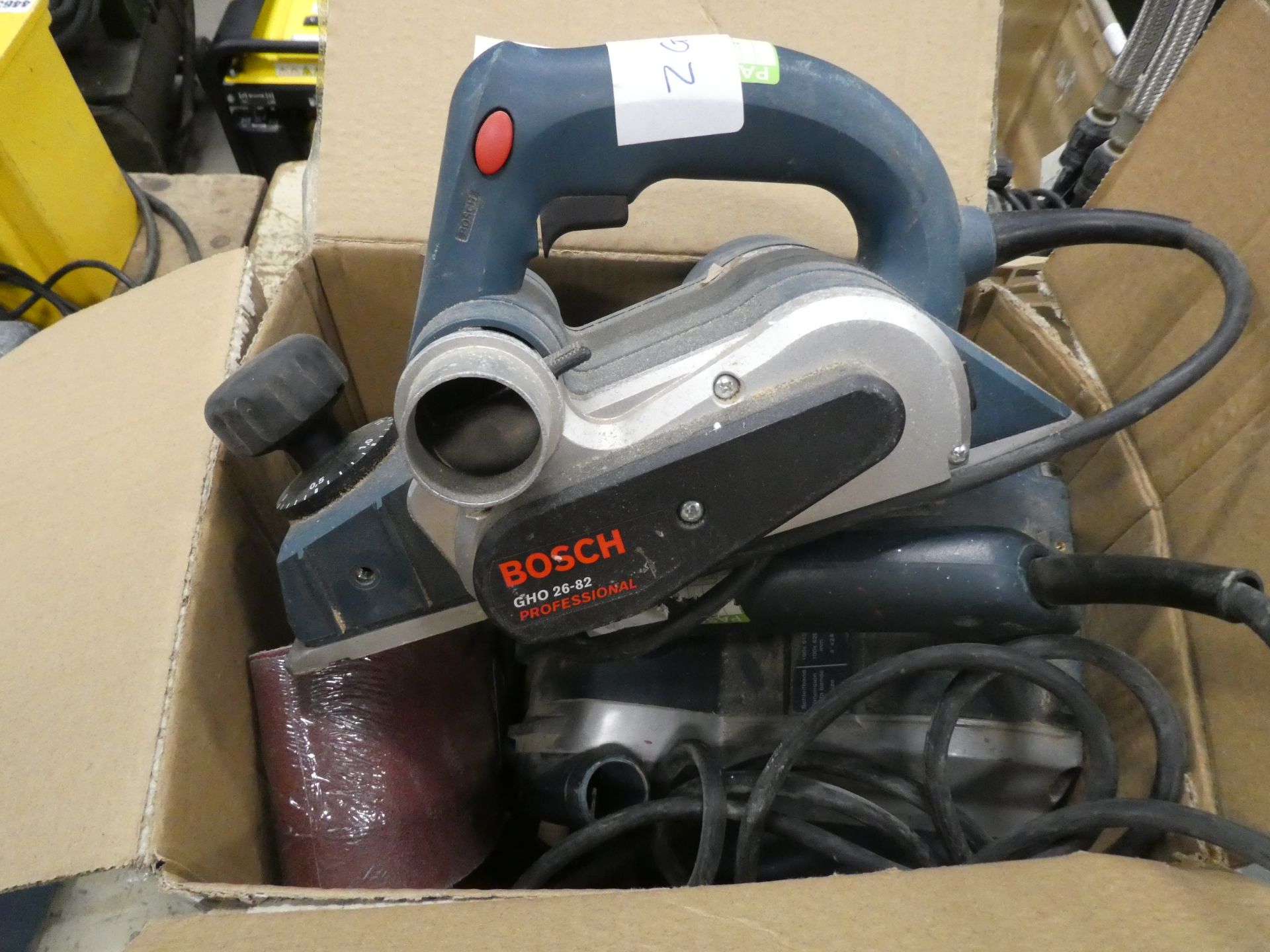 Box containing Bosch sander and electric plane