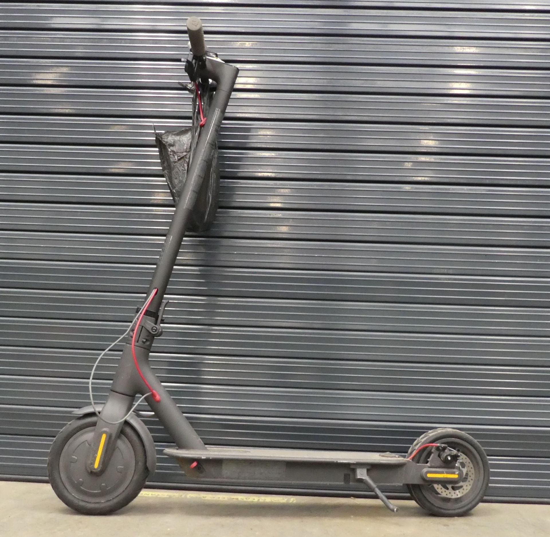 Grey electric scooter with charger