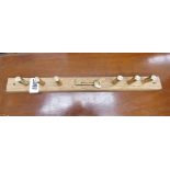 Key rack with brass cartridge hooks