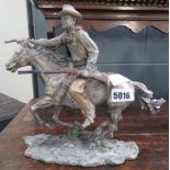 Painted resin figure of a cowboy on a horse