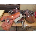 3 leather horses' saddles