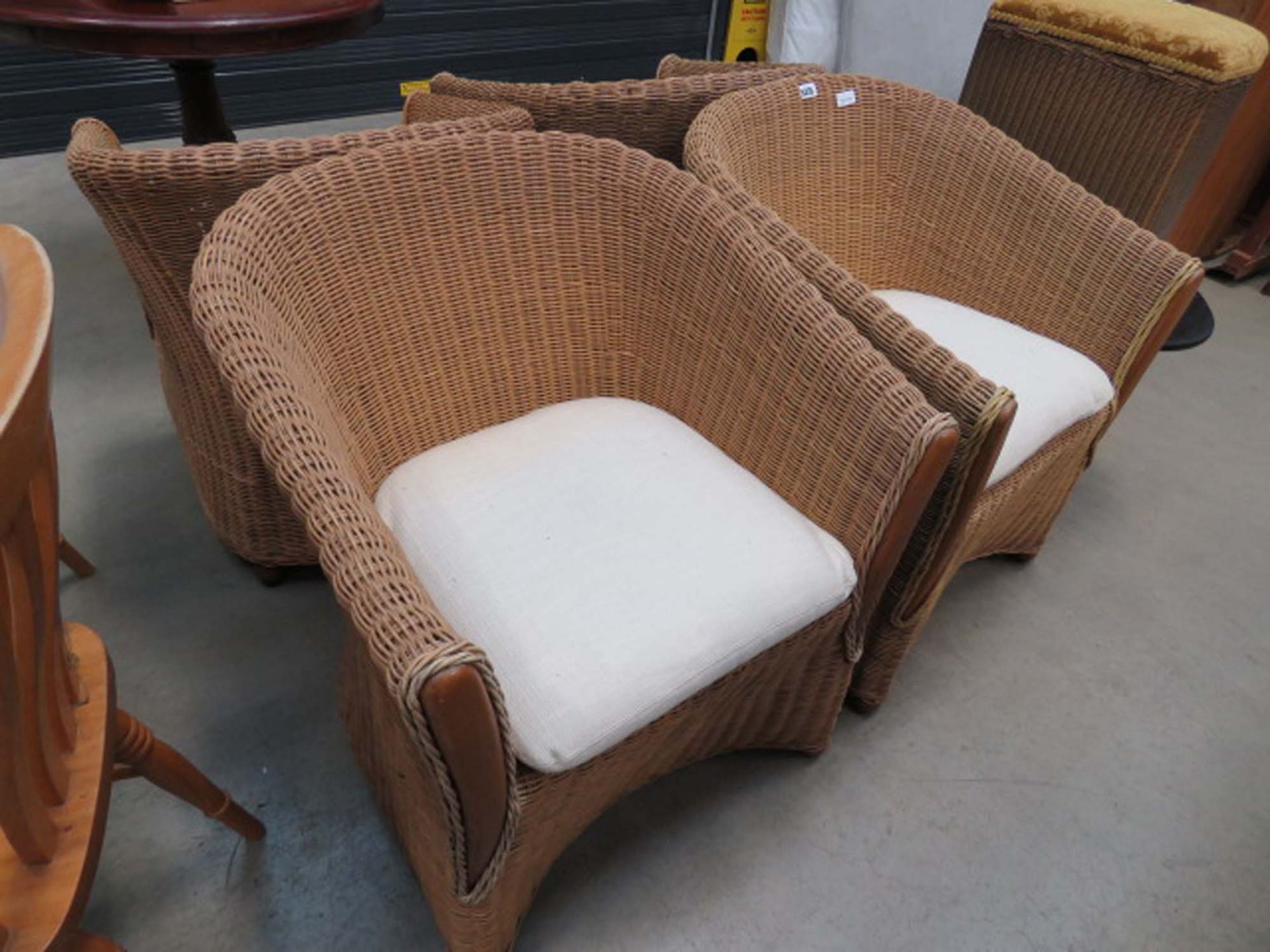 Four wicker conservatory chairs with oatmeal seats