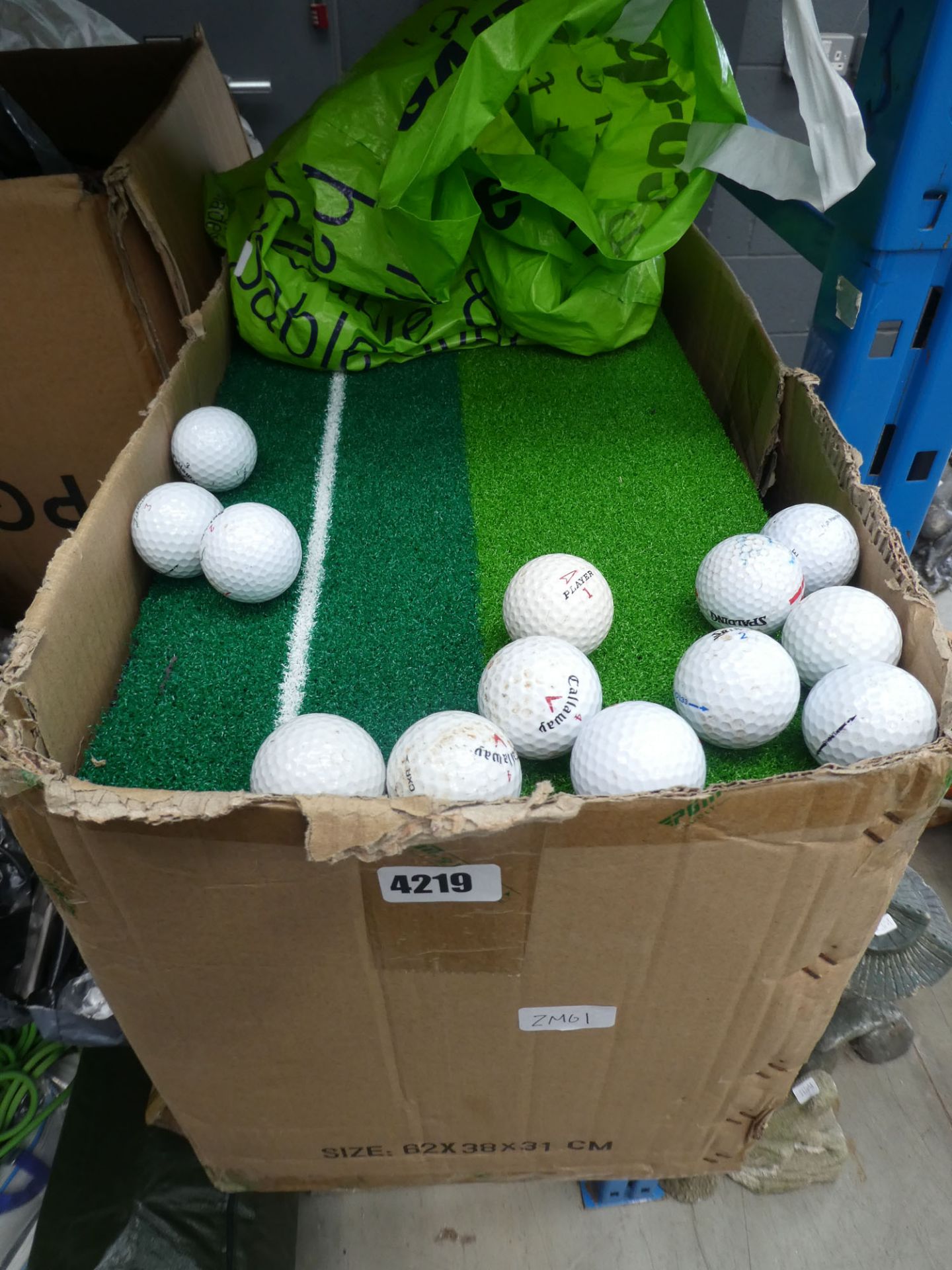 Large quantity of golf accessories to include artificial driving mat, golf balls, tees etc