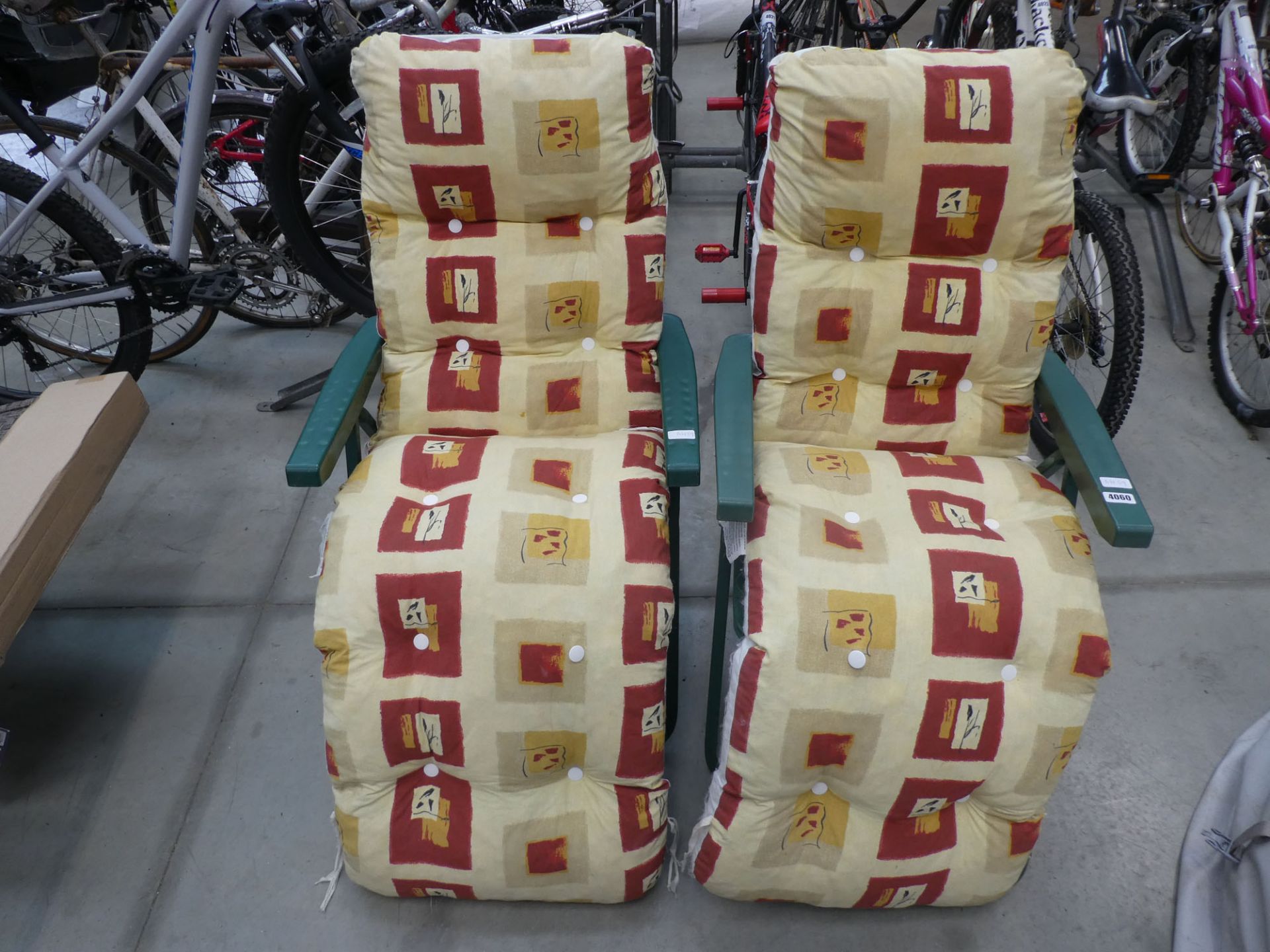 Pair of reclining garden chairs in green with square decorated cushions