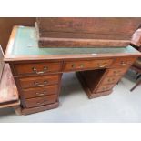 Walnut twin pedestal desk with green leather surface