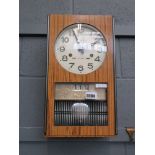 Wall clock in faux walnut case