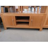 Oak entertainment unit with central shelves and cupboards to the side