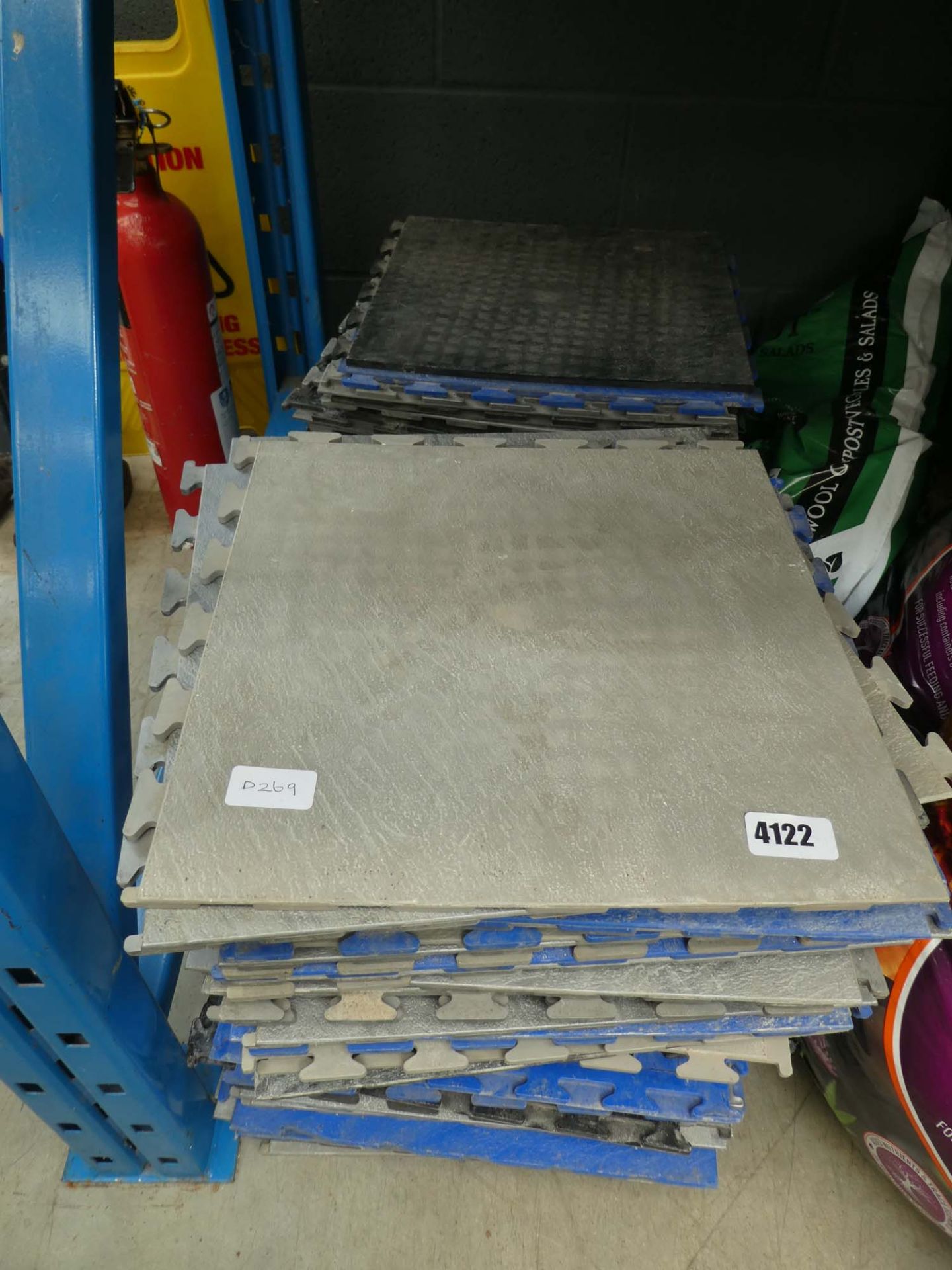 2 stacks of grey and blue click together flooring