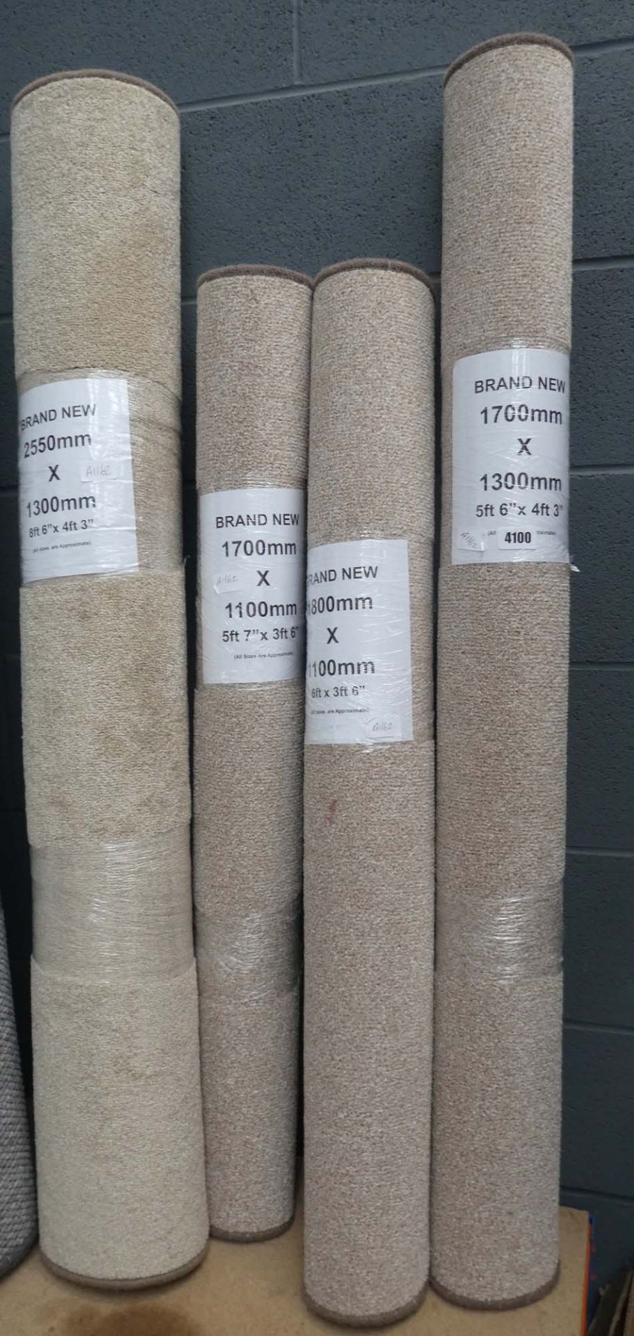 4101 4 beige rolls of carpet mats in various sizes