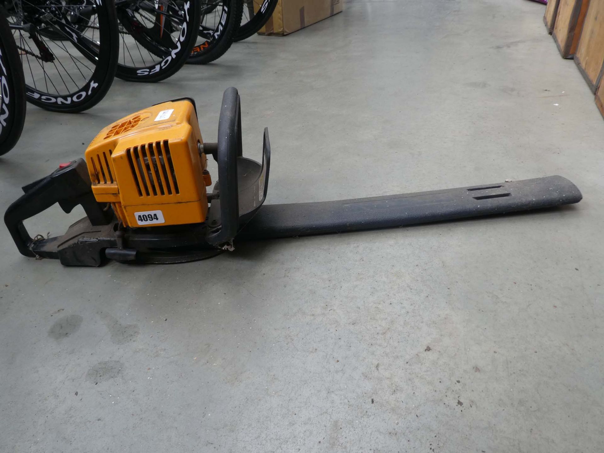 Yellow petrol powered hedgecutter