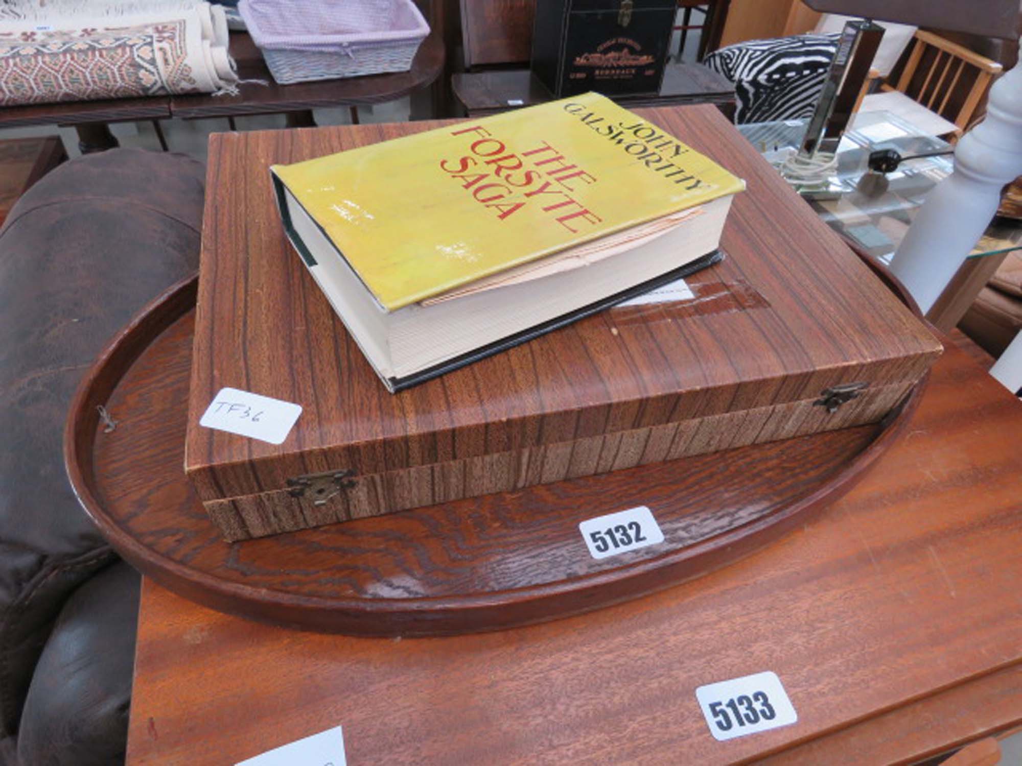 Oval wooden tray together with a book entitled 'Forsythe Saga', and canteen of cutlery