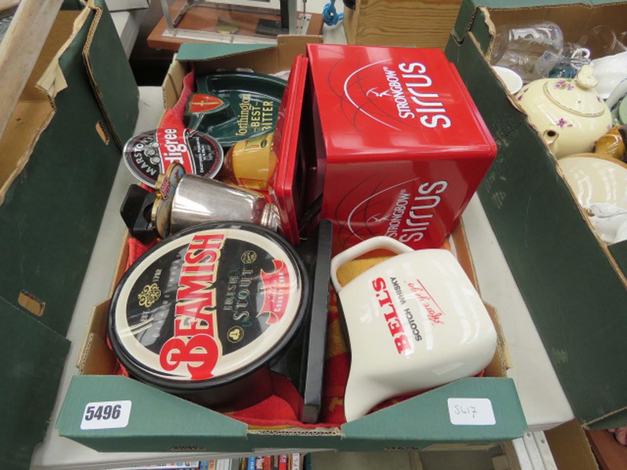 Box containing ice buckets, ale badges and Bells water jug