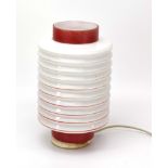 A white opaline glass lamp of concertina form with red highlights, h.