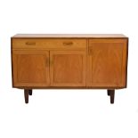 A 1970's G-Plan Fresco Range teak sideboard, the cutlery drawer over three doors, on later legs, l.
