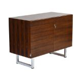 A 1970's rosewood office cabinet with two doors on aluminium block feet, in the manner of Nipu, w.