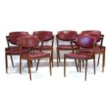 For Refurbishment: a set of fourteen teak and red vinyl elbow chairs in the manner of Kai