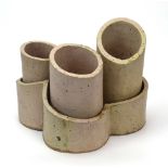 A set of three graduated stoneware planters of slanted cylindrical form contained in a matching