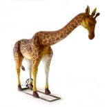 An exterior exhibition life-size figure modelled as a feeding giraffe,