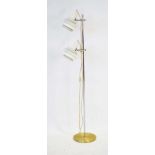 A 1970's floor lamp with two white enamelled shades in the manner of Louis Poulsen,