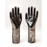 A pair of silvered sculptures modelled as outstretched hands, l.