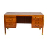 A 1950/60's teak and beech factory desk, the brown vinyl surface over five drawers and two slides,