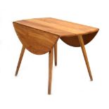 An Ercol elm drop-leaf dining table on beech tapering legs, d.