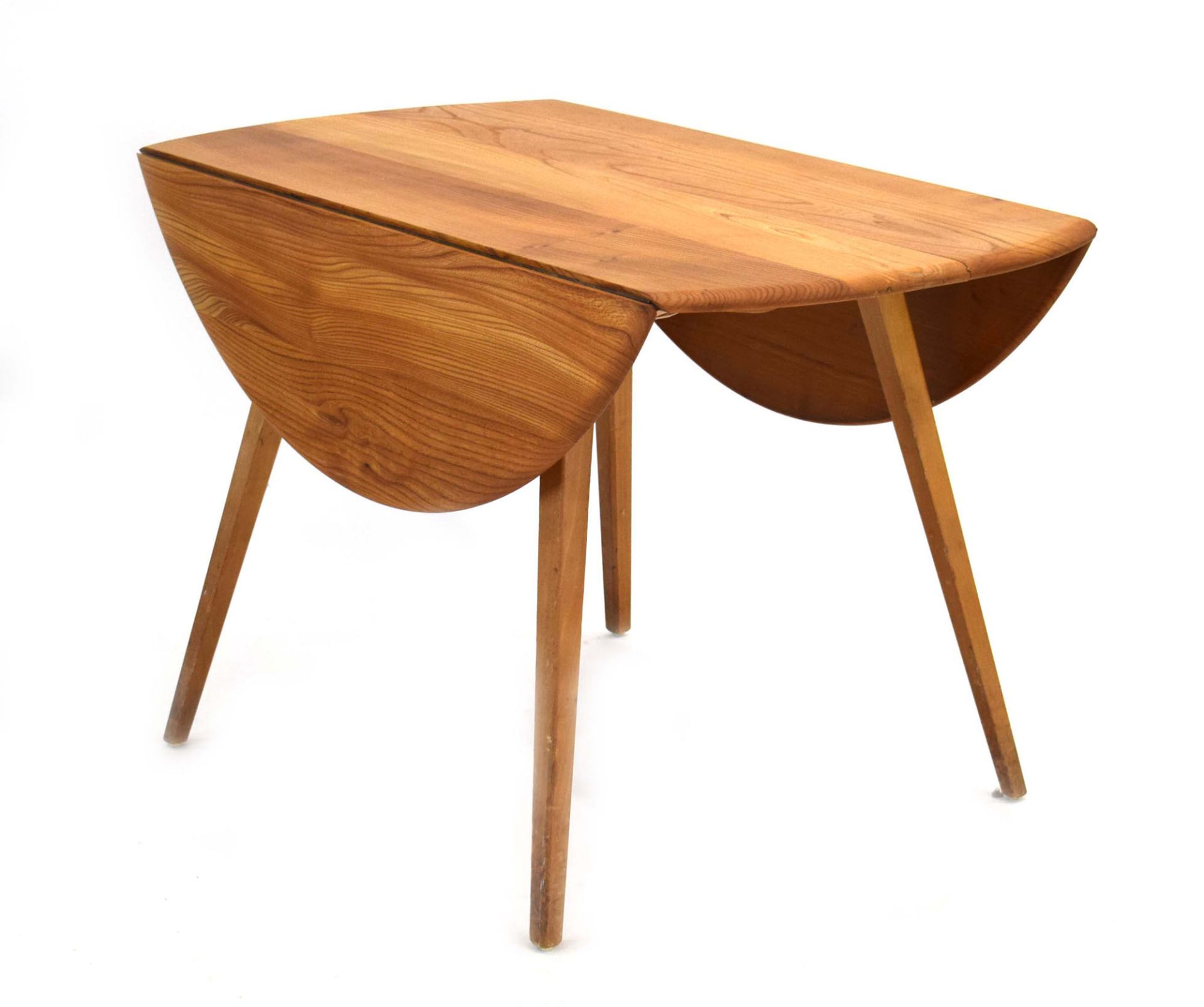 An Ercol elm drop-leaf dining table on beech tapering legs, d.