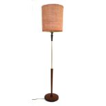 A 1970's teak and brass finished standard lamp with a spun shade CONDITION REPORT: