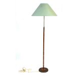 A 1960's teak segmented floor lamp with a brass finished base CONDITION REPORT: Lead