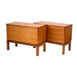 A pair of teak cabinets with fall fronts, on later block feet with exposed joints, w.