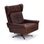 A 1960/70's Danish brown leather and button upholstered wingback armchair on a five-star swivel