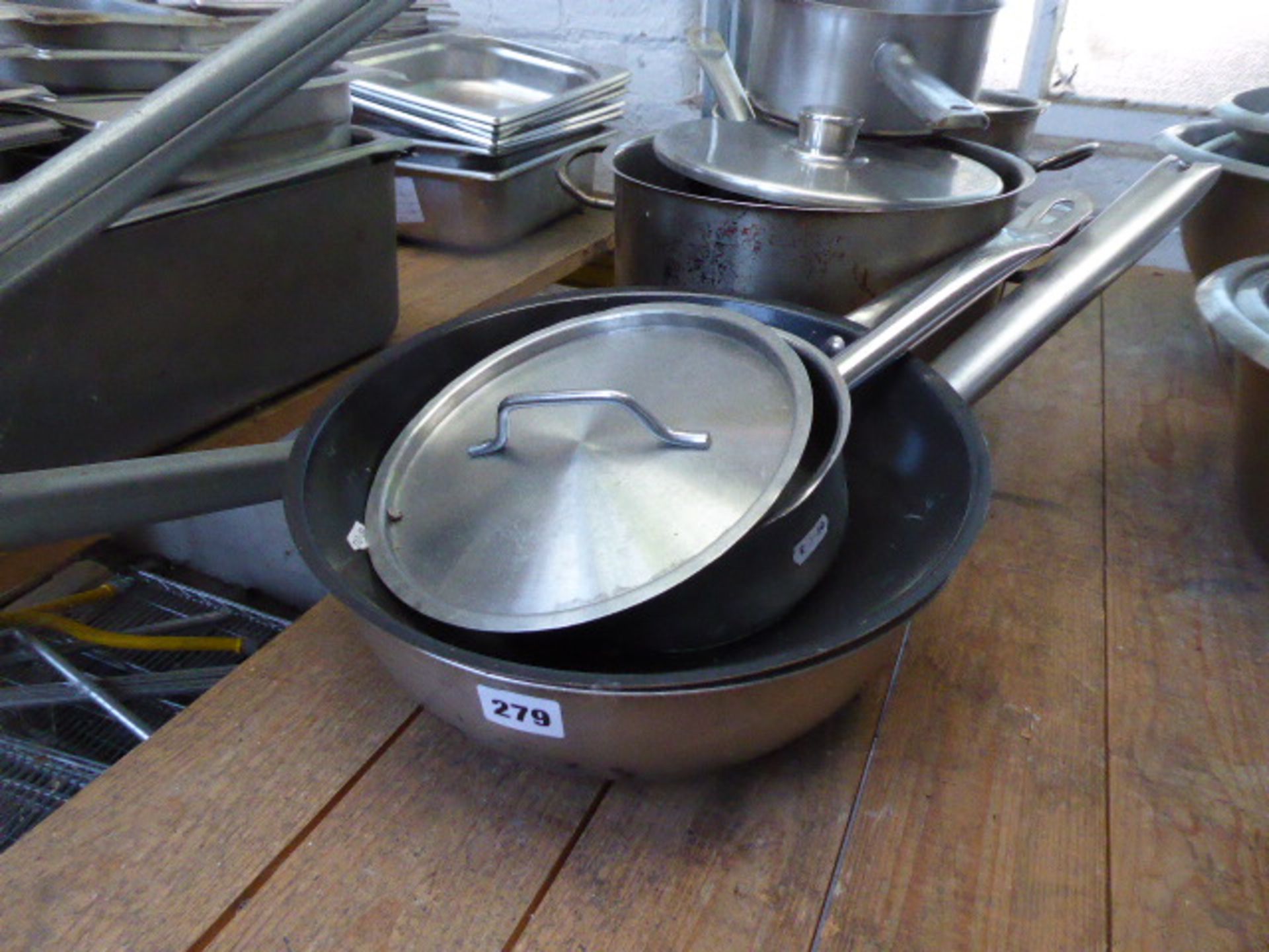7 assorted stainless steel and aluminium cooking pots, some with lids