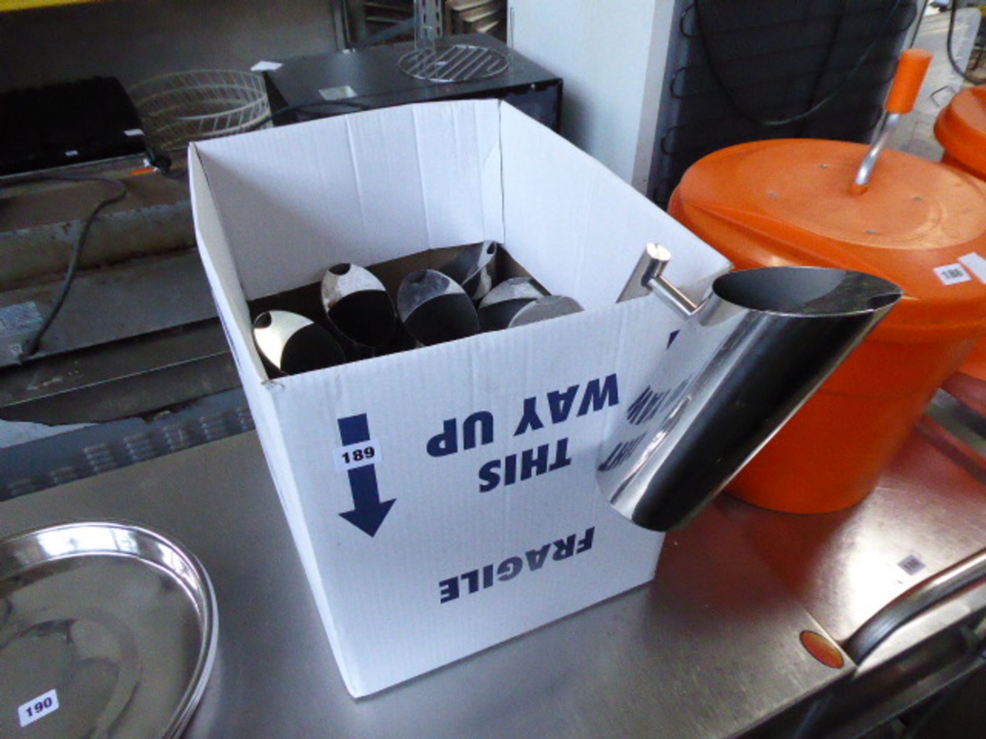 Large box containing stainless steel water jugs