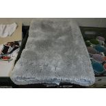 Crate of various grey bath mats