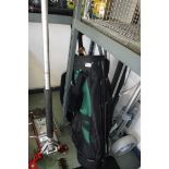TaylorMade golf bag containing 2 clubs with 2 wheeled collapsible golf trolley