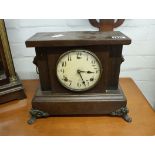 Wooden cased mantle clock with lion's head details