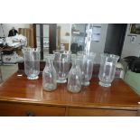 4 identical glass vases and 2 glass bottles