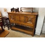 Dark oak heavily carved sideboard with two central drawers and two cupboards