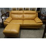 Modern mustard leather upholstered lounge suite comprising a two seater sofa and matching foot