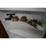 Small quantity of carved wooden ornamental clock garnitures, etc.