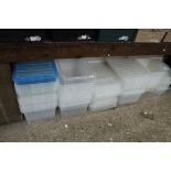 Under bay of clear plastic storage boxes, many with lids