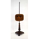 A 19th century rosewood pole screen, the screen depicting putti and cherubs, on a pole,