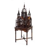 A reproduction elaborate mahogany bird cage on stand, total h.